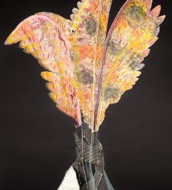 Welded steel base erupts into coloful delicate looking fabric wings.