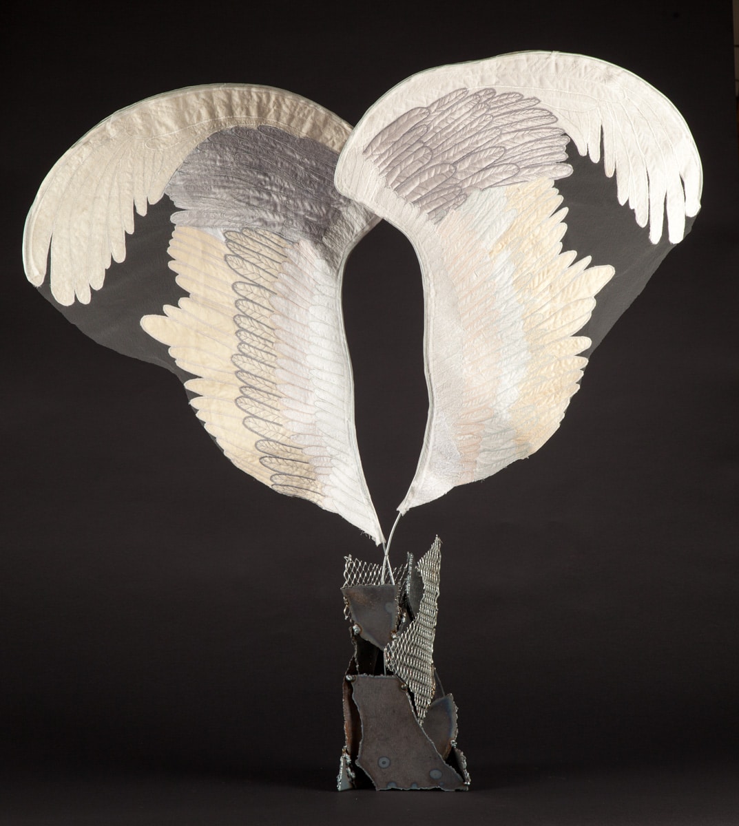 Welded steel base erupts into soft looking fabric wings.
